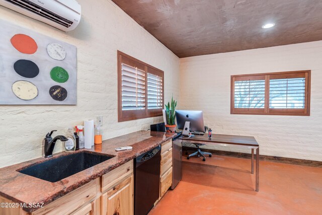 office space featuring plenty of natural light, a wall unit AC, concrete floors, and a sink