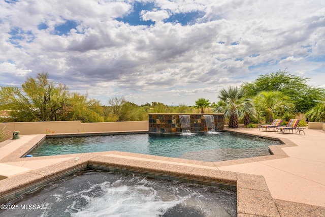 view of swimming pool featuring a jacuzzi, a patio area, and a fenced in pool