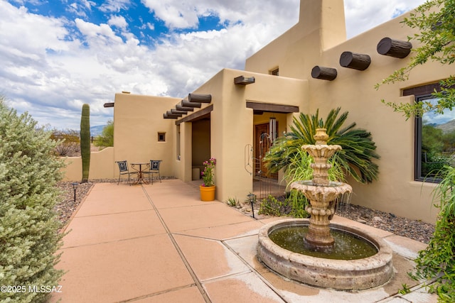 view of patio featuring outdoor dining area and fence