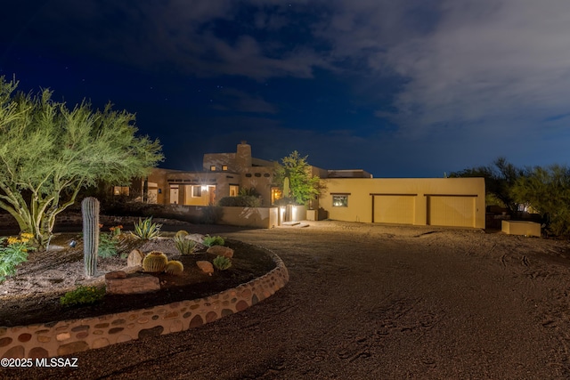 view of front of property with stucco siding and an attached garage