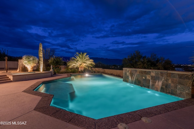 pool at twilight featuring an outdoor pool and a patio