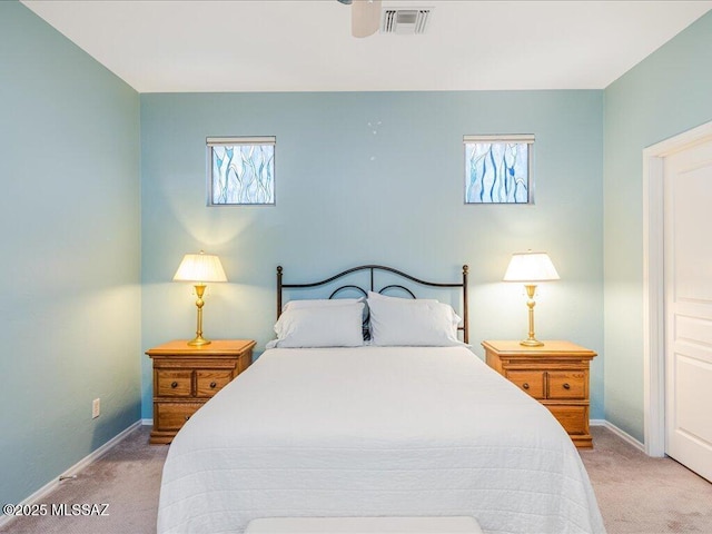 bedroom with multiple windows, visible vents, and carpet floors