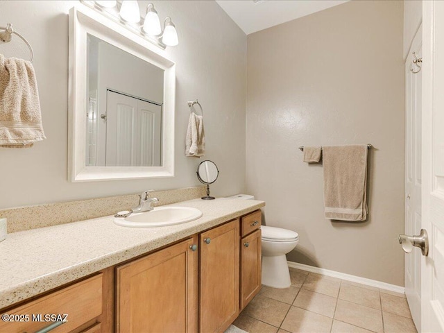 bathroom featuring tile patterned floors, toilet, vanity, and baseboards