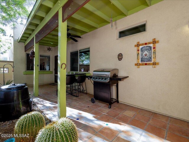 view of patio / terrace featuring a ceiling fan and a grill