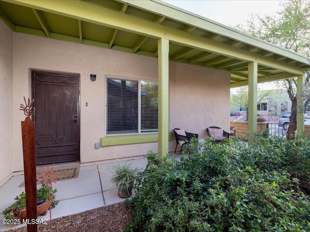 property entrance featuring stucco siding