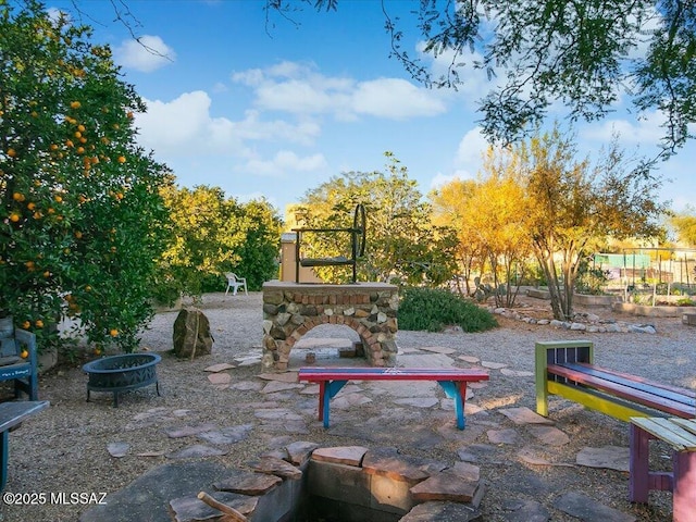 view of community with a fire pit