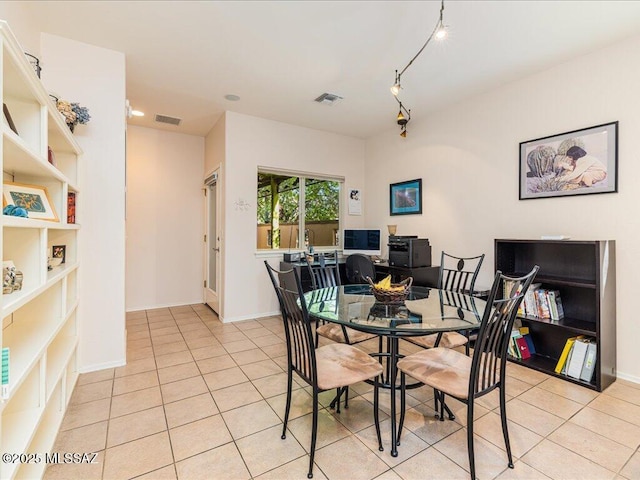 dining space with light tile patterned floors, visible vents, and baseboards