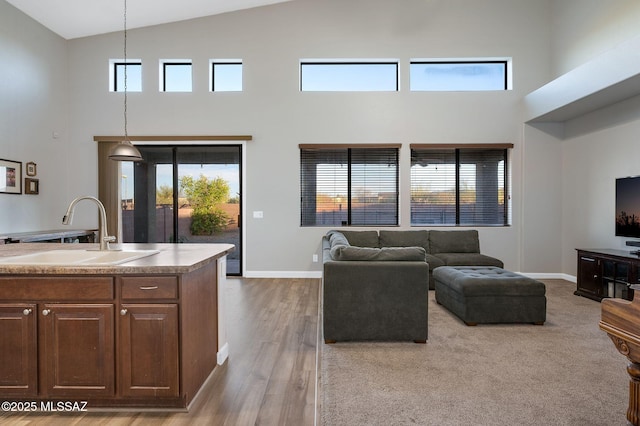 living area featuring high vaulted ceiling, baseboards, and plenty of natural light