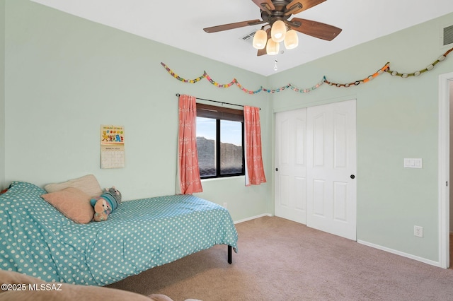 bedroom featuring carpet, ceiling fan, baseboards, and a closet