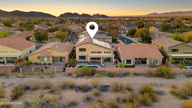 aerial view at dusk with a mountain view and a residential view