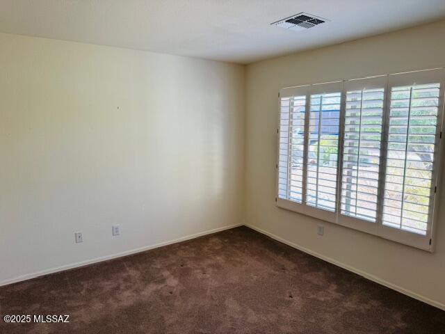 1370 N Birds Nest Rd, Green Valley, AZ 85614 - empty room featuring baseboards, visible vents, and dark carpet
