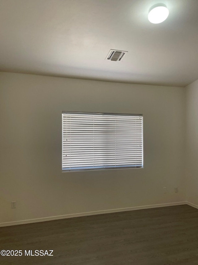 6610 S Via Molino De Viento, Tucson, AZ 85757 - unfurnished room with baseboards, dark wood-style floors, and healthy amount of natural light