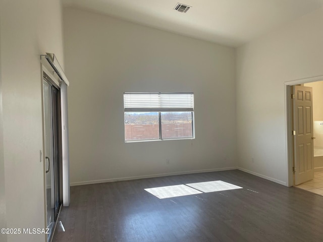 6610 S Via Molino De Viento, Tucson, AZ 85757 - unfurnished bedroom featuring wood finished floors, baseboards, and connected bathroom