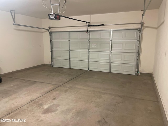 6610 S Via Molino De Viento, Tucson, AZ 85757 - garage with a garage door opener and baseboards