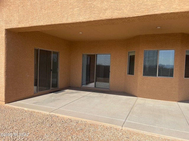 6610 S Via Molino De Viento, Tucson, AZ 85757 - rear view of house with stucco siding and a patio area