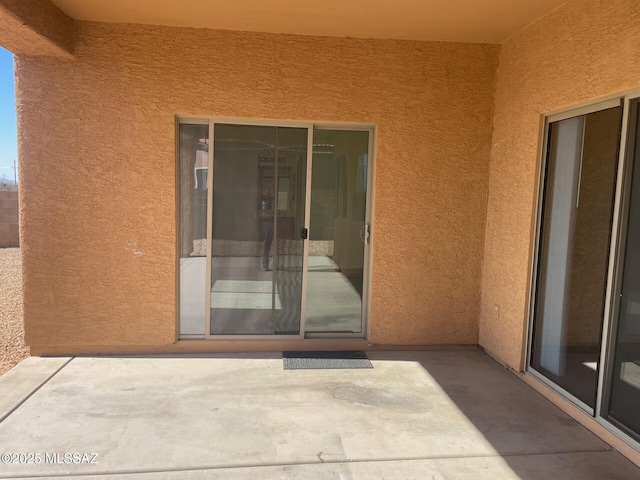 6610 S Via Molino De Viento, Tucson, AZ 85757 - view of exterior entry featuring stucco siding and a patio area