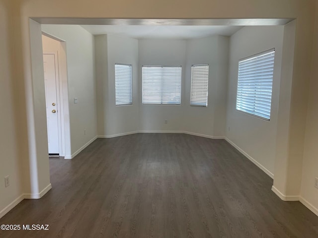 6610 S Via Molino De Viento, Tucson, AZ 85757 - spare room featuring dark wood-style floors and baseboards