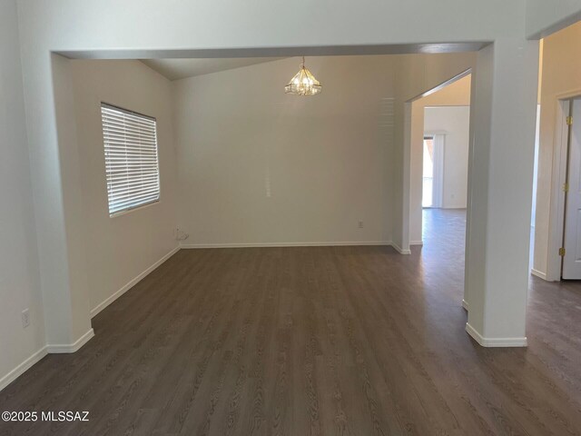 6610 S Via Molino De Viento, Tucson, AZ 85757 - spare room featuring dark wood-type flooring, baseboards, and a chandelier