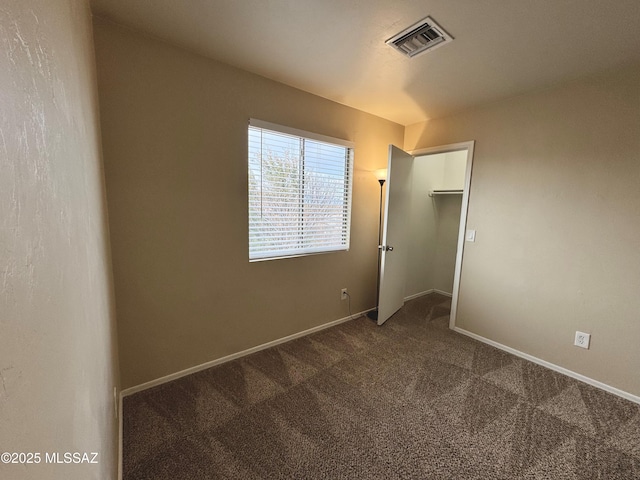 unfurnished bedroom with baseboards, visible vents, and carpet flooring