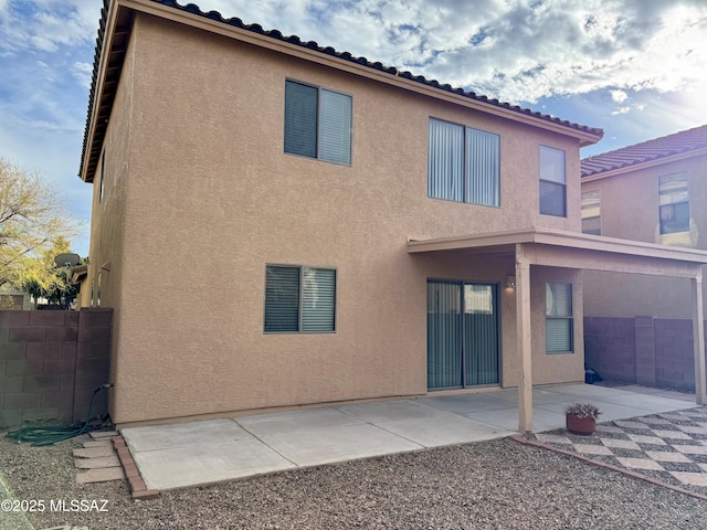 back of house featuring stucco siding, fence, and a patio area