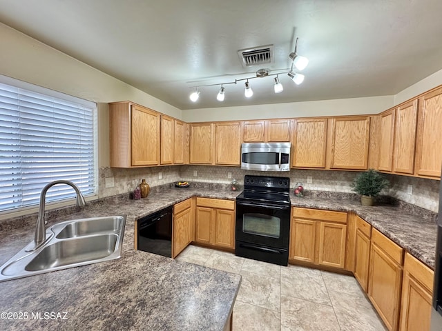 kitchen with visible vents, dark countertops, tasteful backsplash, a sink, and black appliances