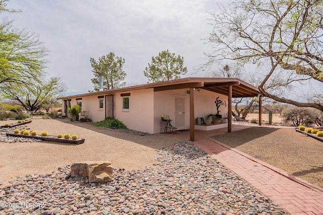 back of property featuring stucco siding and a patio area