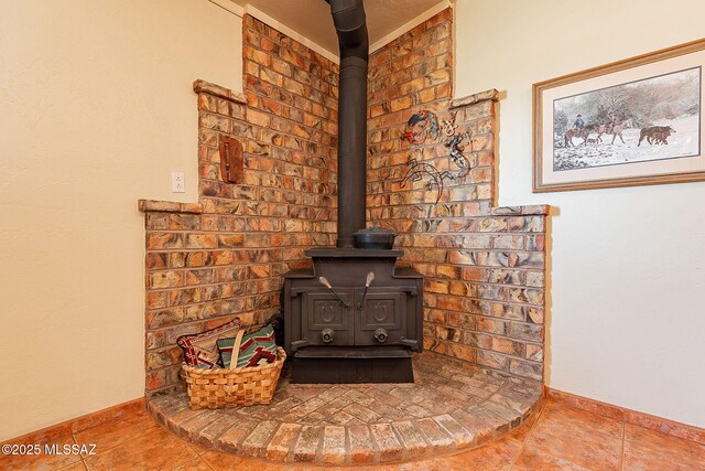 interior details with baseboards and a wood stove