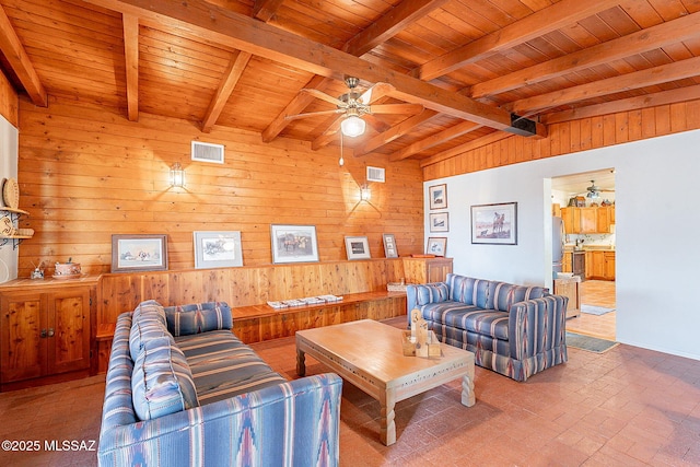 living room featuring wood walls, wood ceiling, brick floor, visible vents, and a ceiling fan