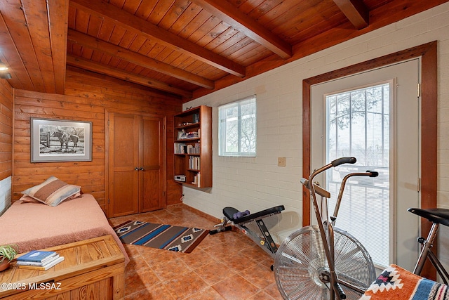 workout area with tile patterned flooring, wood ceiling, wood walls, and lofted ceiling