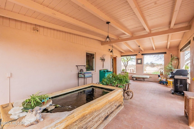 exterior space featuring beam ceiling