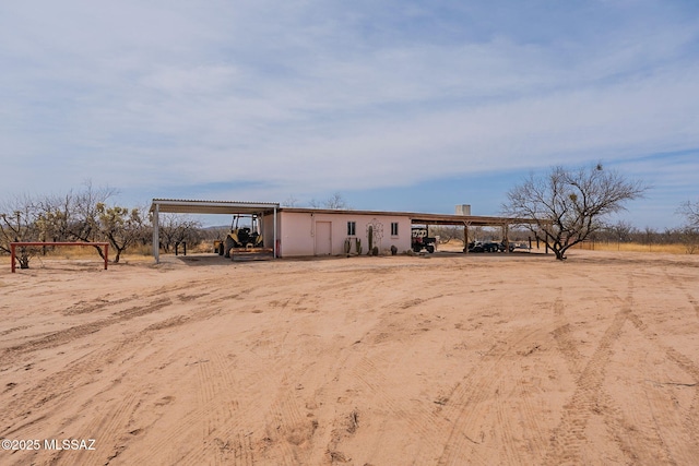 exterior space with a carport