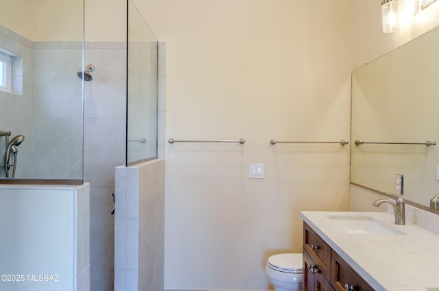 full bath with toilet, vanity, and a walk in shower