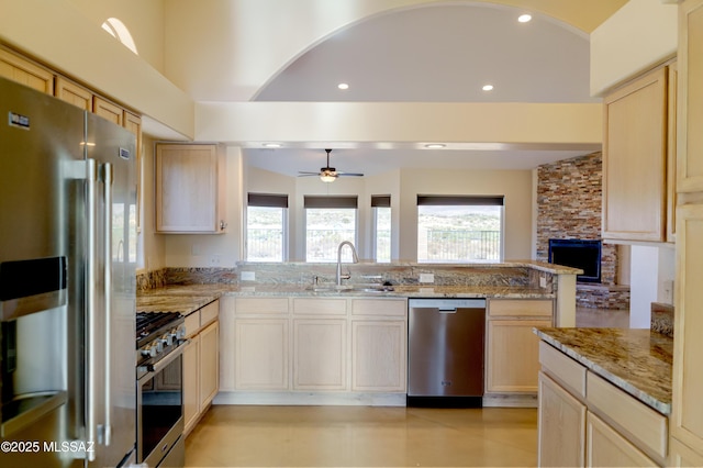 kitchen with recessed lighting, a wealth of natural light, stainless steel appliances, and a sink