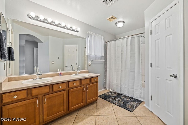 15046 S Harry Truman Pl, Sahuarita, AZ 85629 - full bath featuring double vanity, tile patterned floors, and shower / bathtub combination with curtain
