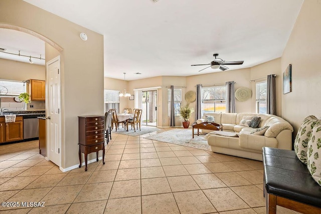 15046 S Harry Truman Pl, Sahuarita, AZ 85629 - living room featuring light tile patterned floors, plenty of natural light, arched walkways, and ceiling fan