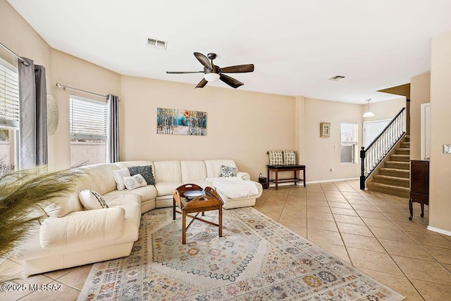 15046 S Harry Truman Pl, Sahuarita, AZ 85629 - living room featuring light tile patterned floors, stairs, a ceiling fan, and baseboards