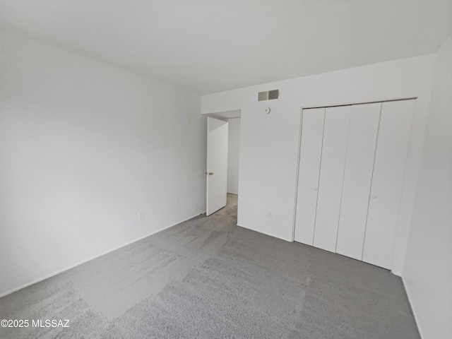 6588 Calle La Paz Unit C, Tucson, AZ 85715 - unfurnished bedroom featuring visible vents, a closet, and carpet