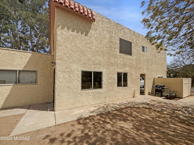 6588 Calle La Paz Unit C, Tucson, AZ 85715 - rear view of property featuring stucco siding, a tiled roof, and a patio