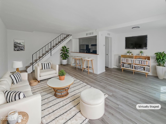 6588 Calle La Paz Unit C, Tucson, AZ 85715 - living area with stairs, visible vents, and wood finished floors