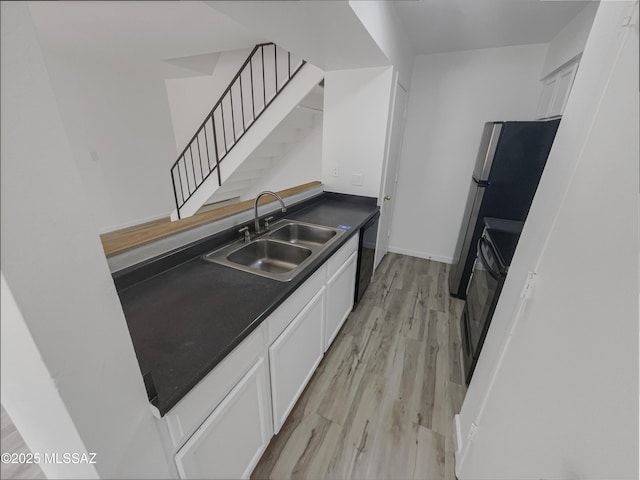 6588 Calle La Paz Unit C, Tucson, AZ 85715 - kitchen featuring dark countertops, white cabinets, a sink, and dishwasher