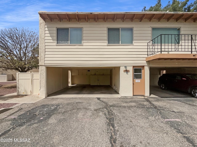 6588 Calle La Paz Unit C, Tucson, AZ 85715 - view of front facade with a balcony, aphalt driveway, and an attached garage
