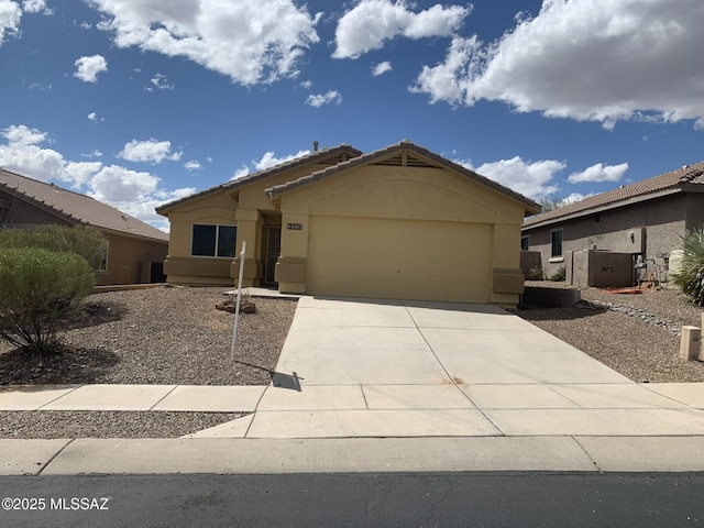 ranch-style house featuring a tiled roof, an attached garage, driveway, and stucco siding