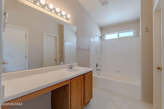 bathroom with vanity, marble finish floor, shower / washtub combination, and visible vents