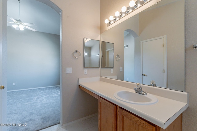 bathroom featuring vanity, baseboards, and a ceiling fan