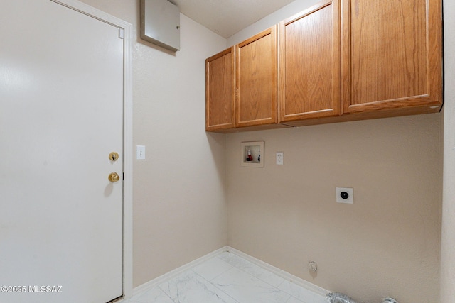 clothes washing area featuring gas dryer hookup, hookup for an electric dryer, cabinet space, marble finish floor, and hookup for a washing machine