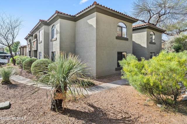 5751 N Kolb Rd Unit 2101, Tucson, AZ 85750 - view of property exterior with stucco siding and a tiled roof