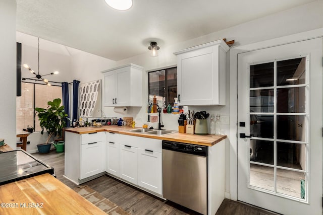kitchen featuring wooden counters, a sink, a notable chandelier, and stainless steel dishwasher