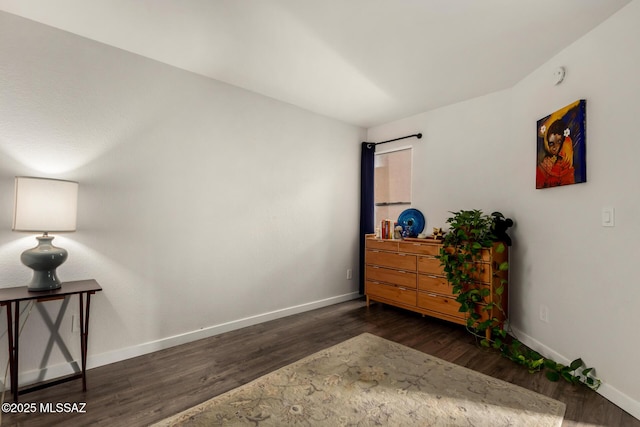 interior space featuring baseboards and wood finished floors