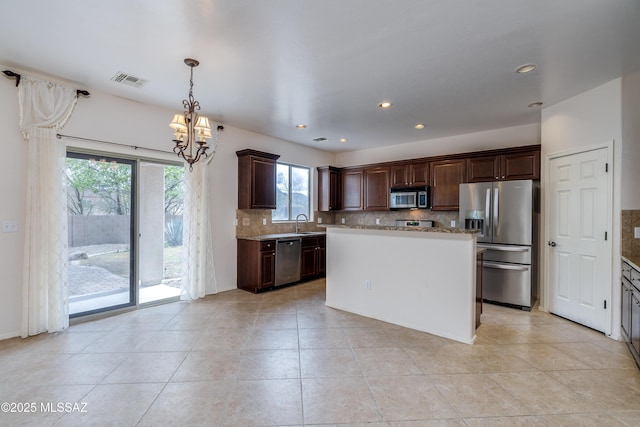 kitchen with a chandelier, decorative backsplash, visible vents, dark brown cabinetry, and appliances with stainless steel finishes