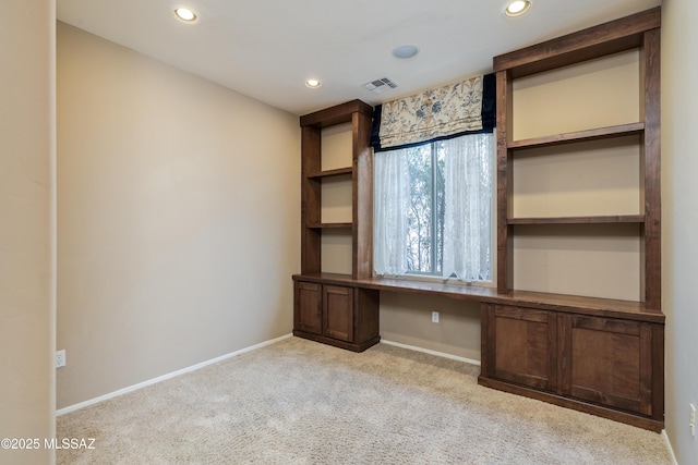 unfurnished office featuring built in study area, recessed lighting, carpet flooring, baseboards, and visible vents